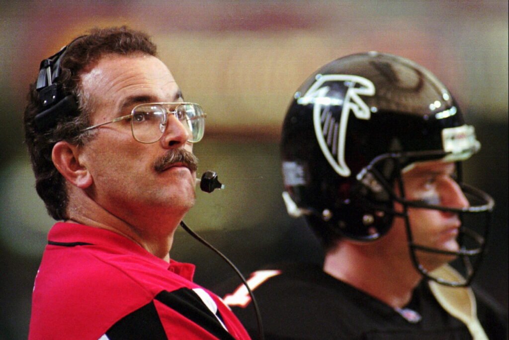 June Jones wearing a headset beside Falcons quarterback Jeff George on November 19, 1995