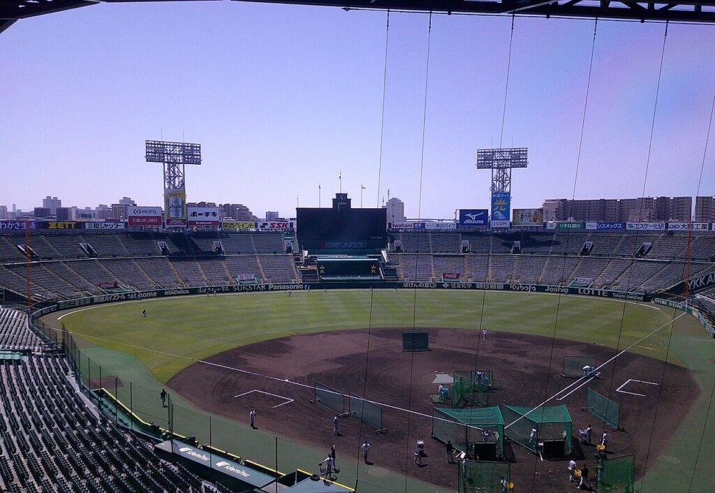 A wide view of Hanshin Koshien Stadium from behind home plate.