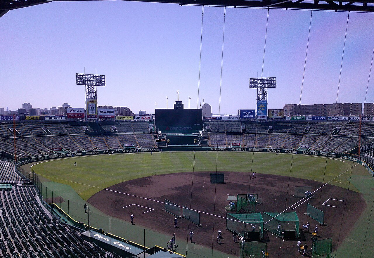 A wide view of Hanshin Koshien Stadium from behind home plate.