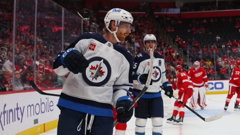 Kyle Connor celebrates with Mark Scheifele during Winnipeg’s game against Detroit at Little Caesars Arena on October 4, 2026.