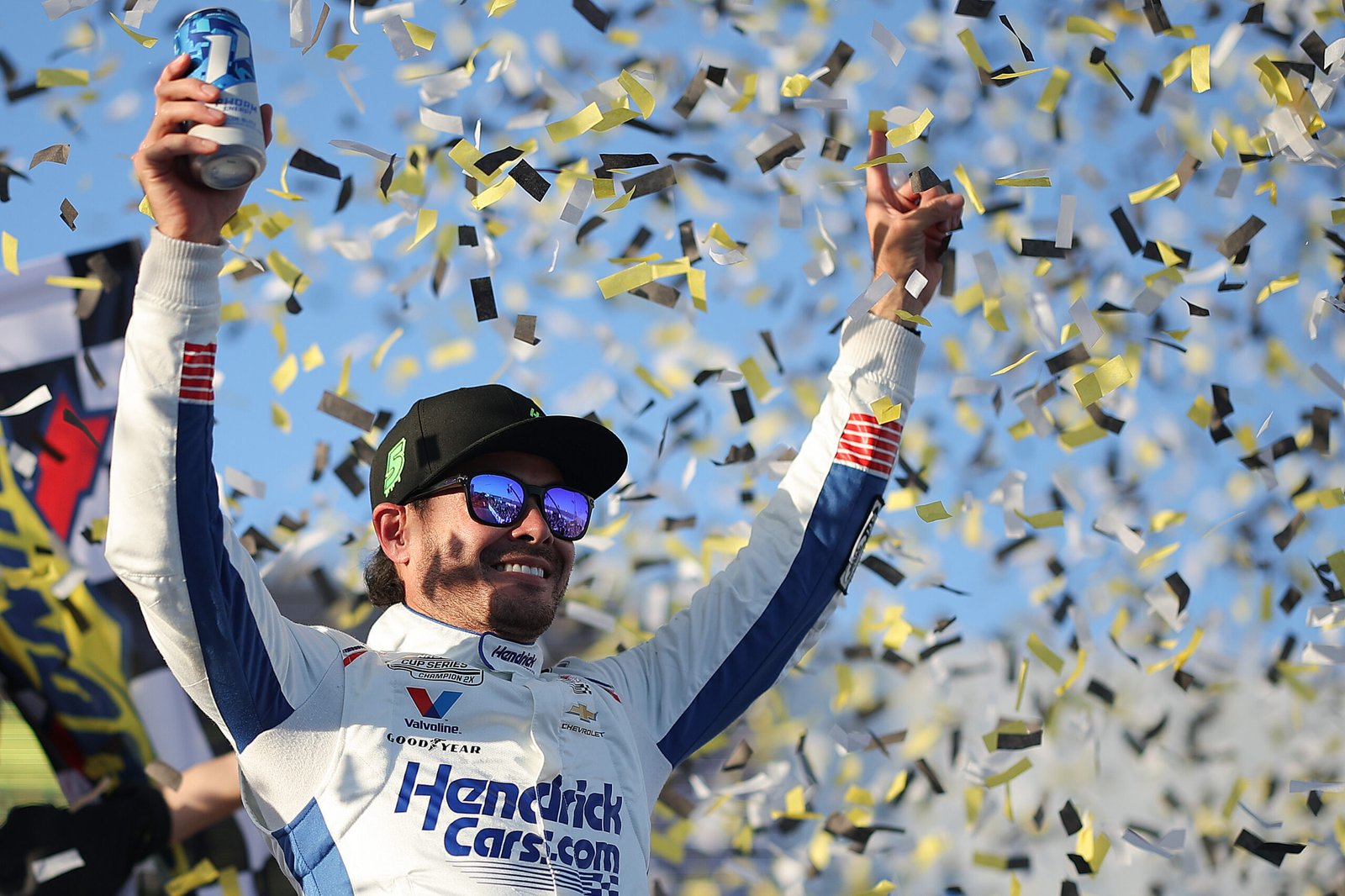 Kyle Larson raises his arms amid confetti in Talladega’s victory lane.