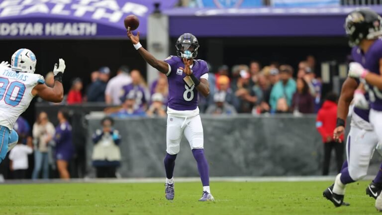 Lamar Jackson throws a pass in a Ravens photograph accompanying the October 4, 2026 injury report.