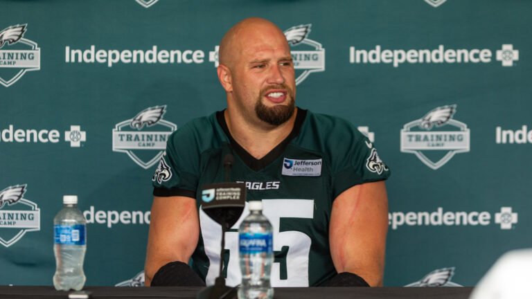 Lane Johnson speaks to reporters in an Eagles number 65 jersey at training camp