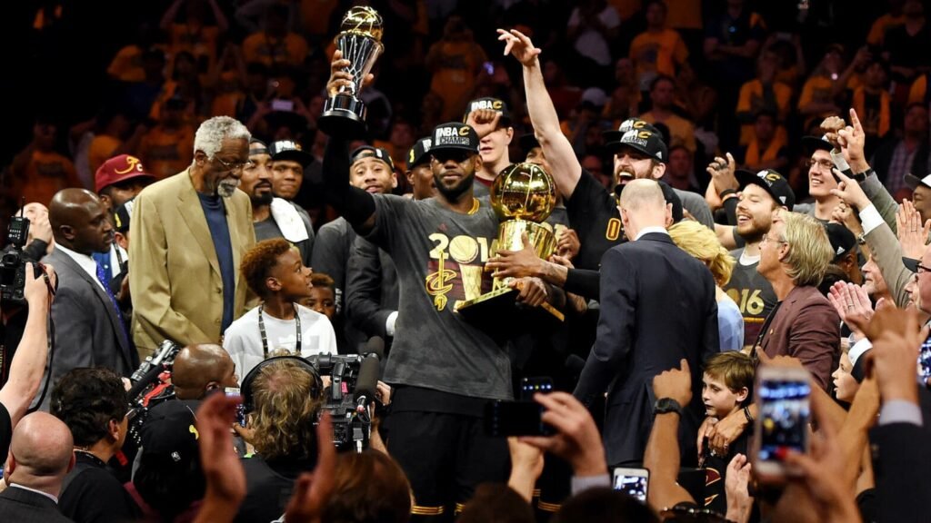 LeBron James holds the Finals MVP trophy during Cleveland’s 2016 championship celebration.