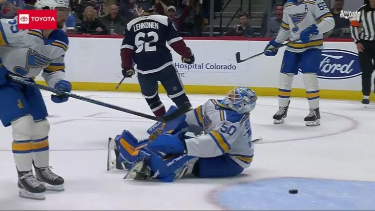 Artturi Lehkonen stands beside Blues goaltender Jordan Binnington during Blues–Avalanche at Ball Arena on October 3, 2026.