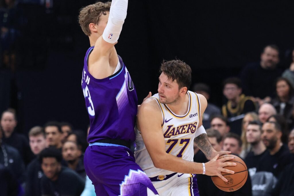 Luka Dončić holds the ball against Lauri Markkanen during the Lakers–Jazz game on October 25, 2026.