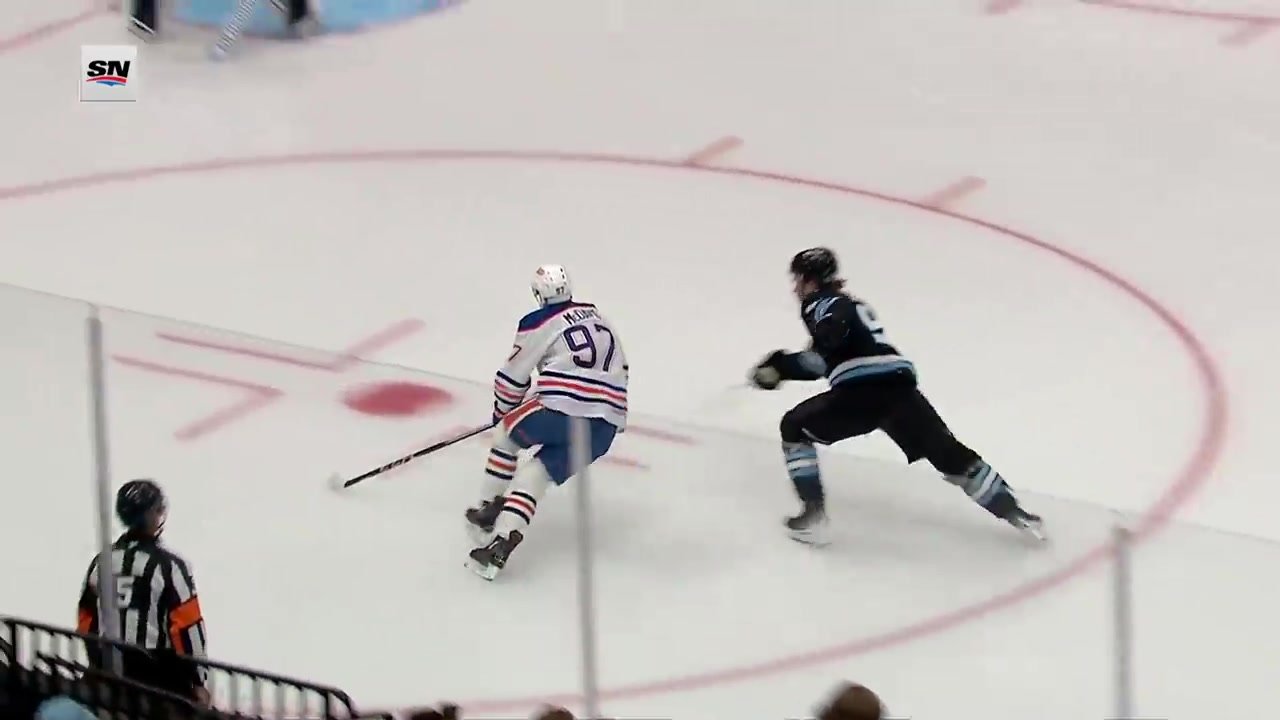 Connor McDavid, wearing number 97, skates ahead of Mikhail Sergachev during Edmonton’s opening goal against Utah on October 17, 2026.