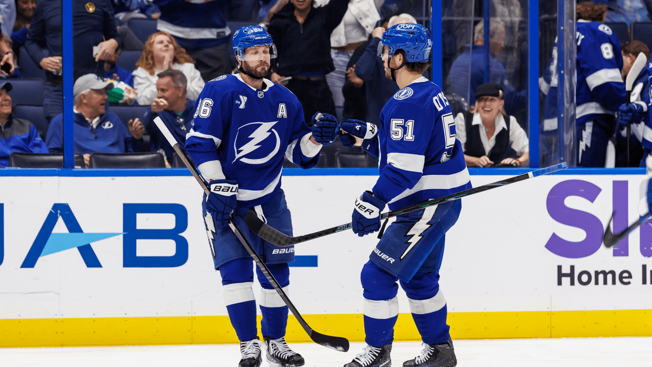 Nikita Kucherov exchanges a glove tap with a Lightning teammate.