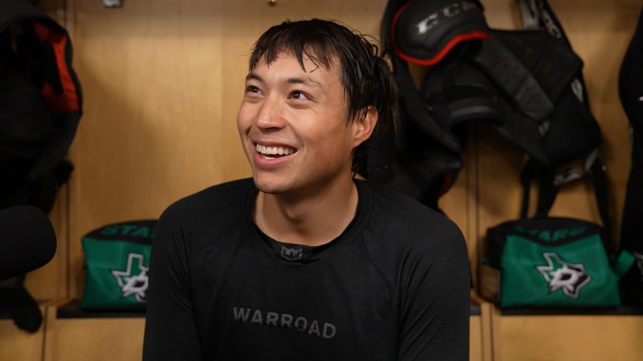 Jason Robertson smiles while speaking in the Dallas Stars locker room.