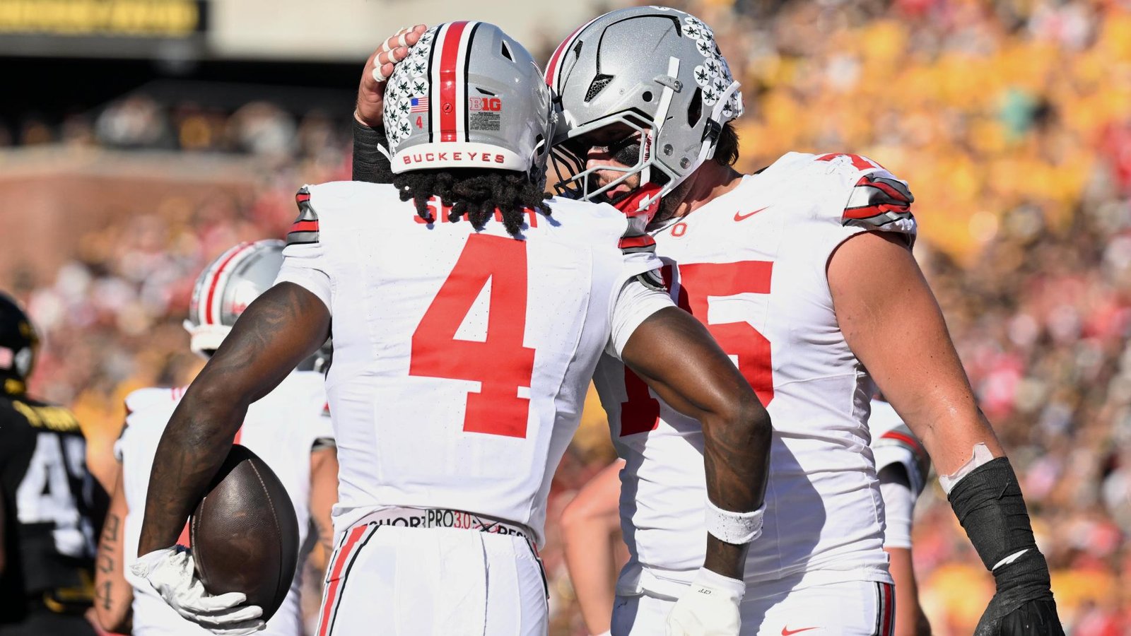 Ohio State receiver Jeremiah Smith, wearing No. 4, celebrates with a teammate at Iowa.