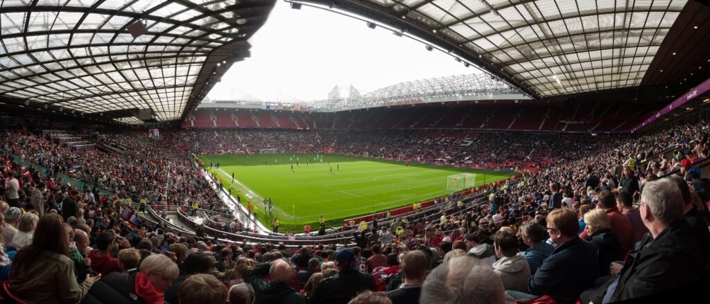 An archival panorama of the pitch and stands at Old Trafford.