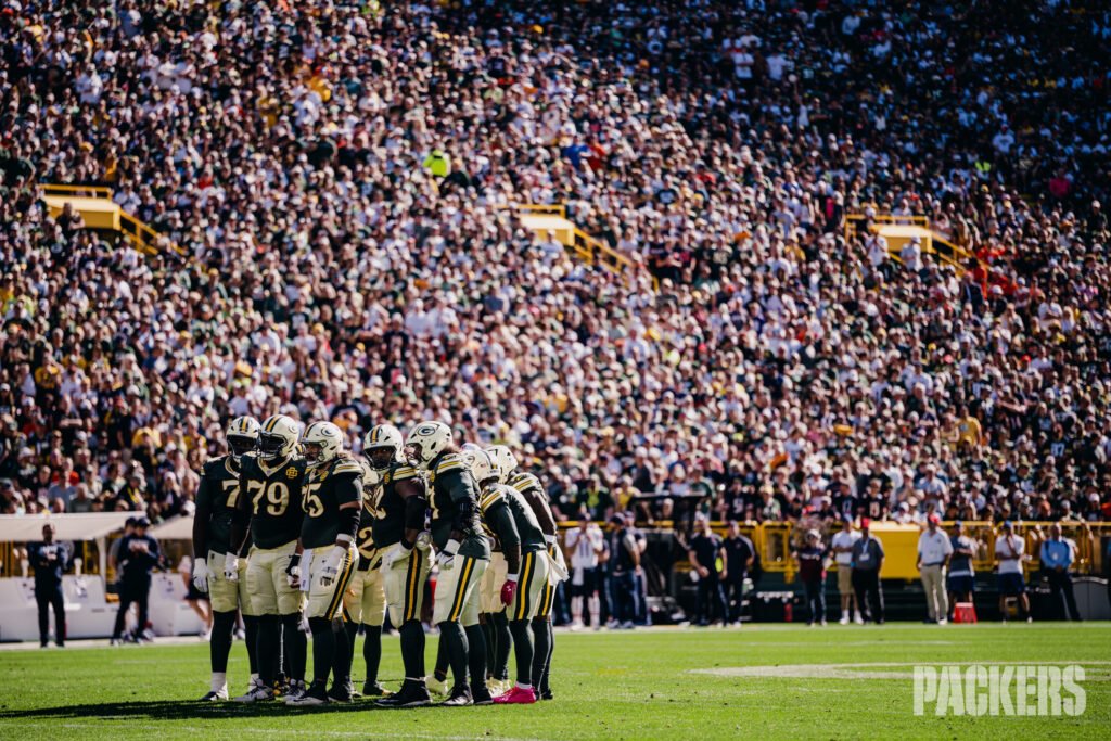 Green Bay Packers players huddle on the Lambeau Field turf before the October 11 game against Chicago.
