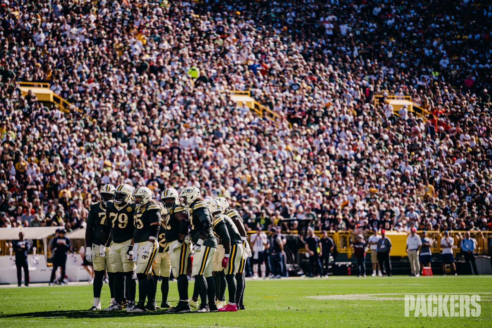 Green Bay Packers players huddle on the Lambeau Field turf before the October 11 game against Chicago.