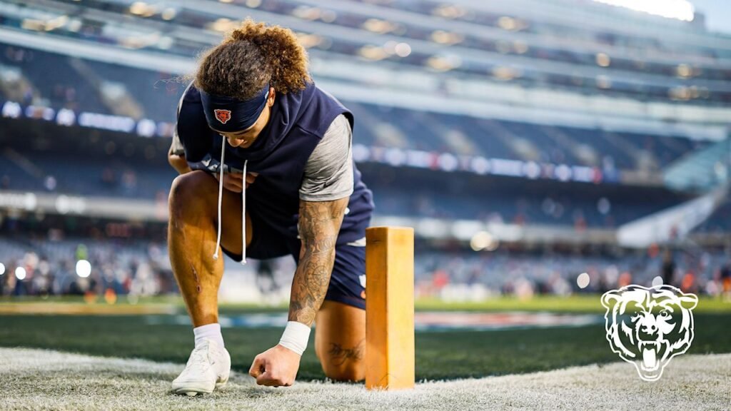 A Chicago Bears player kneels beside an end-zone pylon at Soldier Field before the October 22, 2026 game against New England.