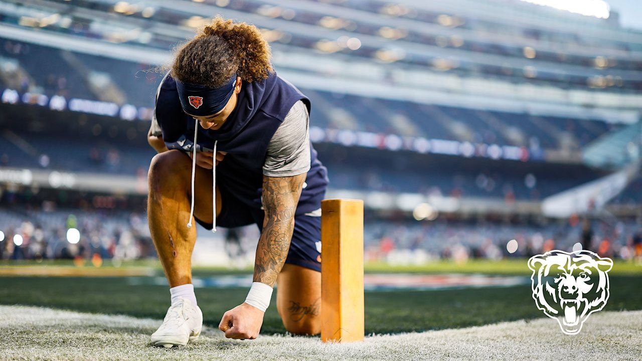 A Chicago Bears player kneels beside an end-zone pylon at Soldier Field before the October 22, 2026 game against New England.