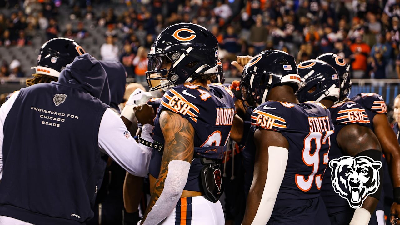 Chicago Bears players in helmets and uniforms gather by the Soldier Field sideline before the October 22, 2026 game against New England.