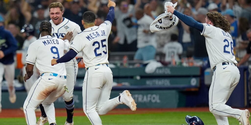 Tampa Bay Rays players celebrate on the field after Game 4.
