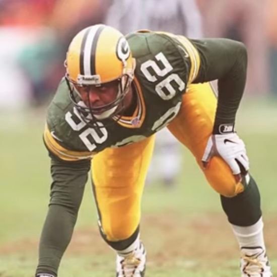 Reggie White in a green and yellow Green Bay Packers number 92 uniform.