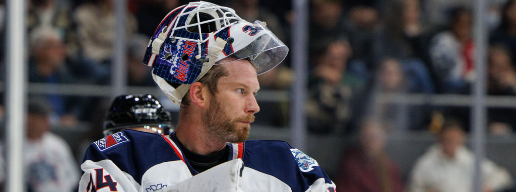 James Reimer in a Hartford Wolf Pack jersey with his mask lifted above his face.