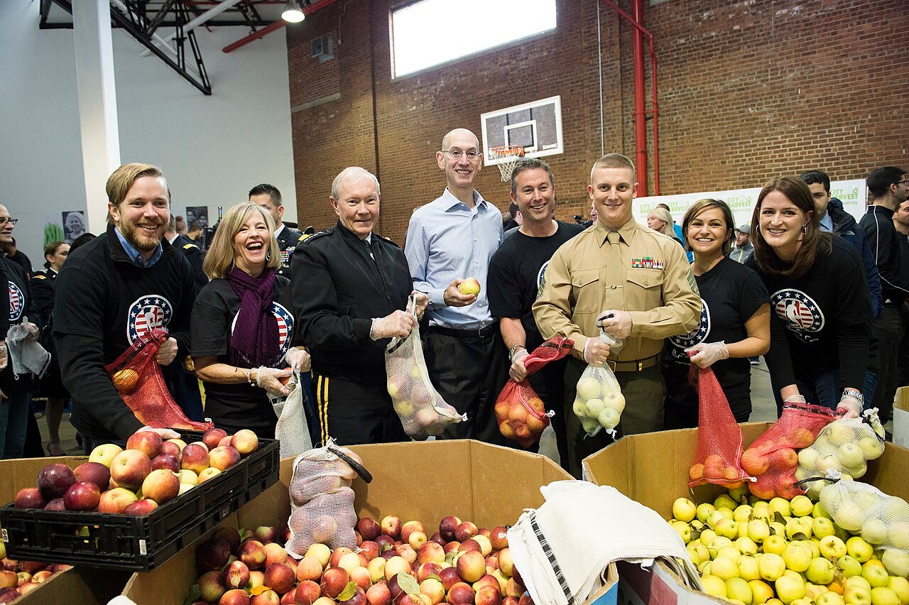 NBA commissioner Adam Silver, centre in a blue shirt, at a City Harvest service event in New York in November 2014.