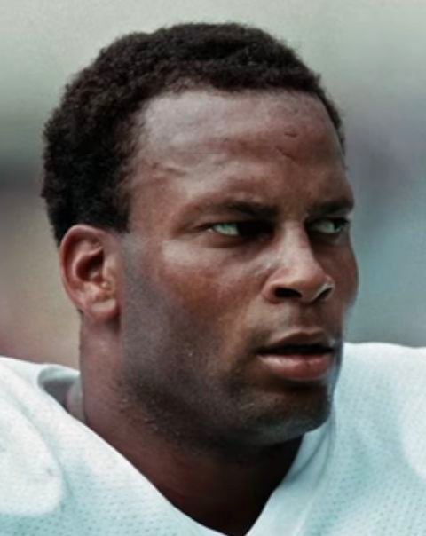 Ronnie Lott in football shoulder pads in an archival image shown by Rushmore Podcast.