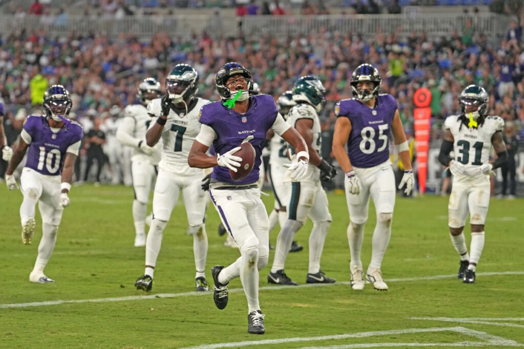 Ja’Kobi Lane carries the football after a touchdown against Philadelphia.