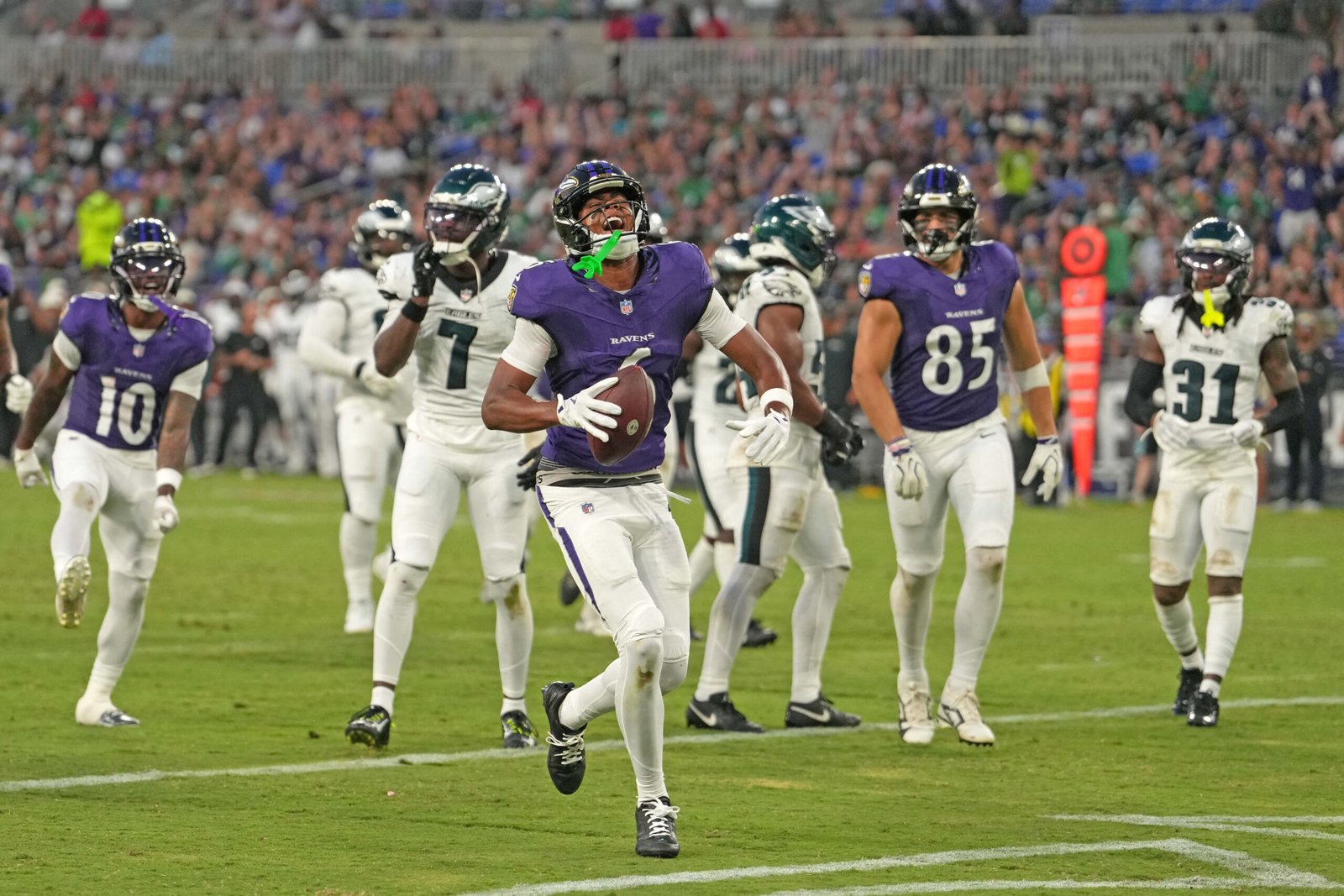 Ja’Kobi Lane carries the football after a touchdown against Philadelphia.