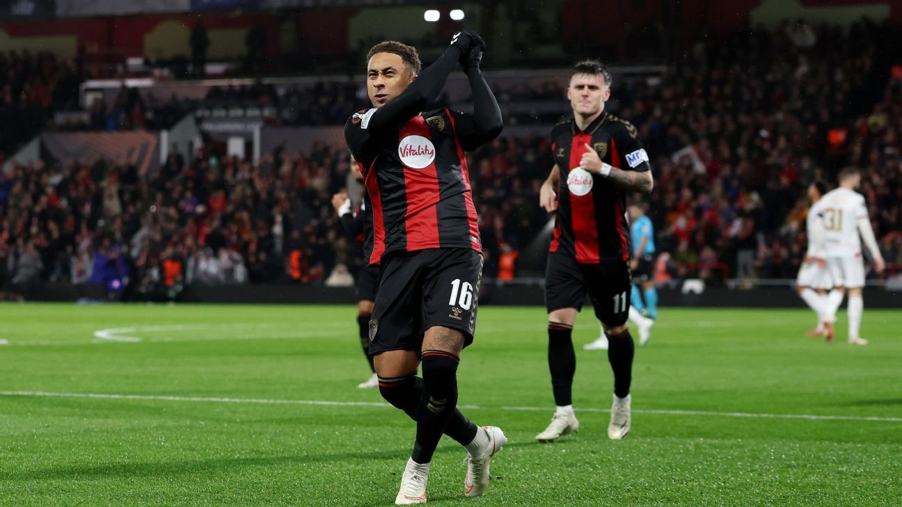 A Bournemouth player applauds on the pitch with teammates and AC Milan players nearby.