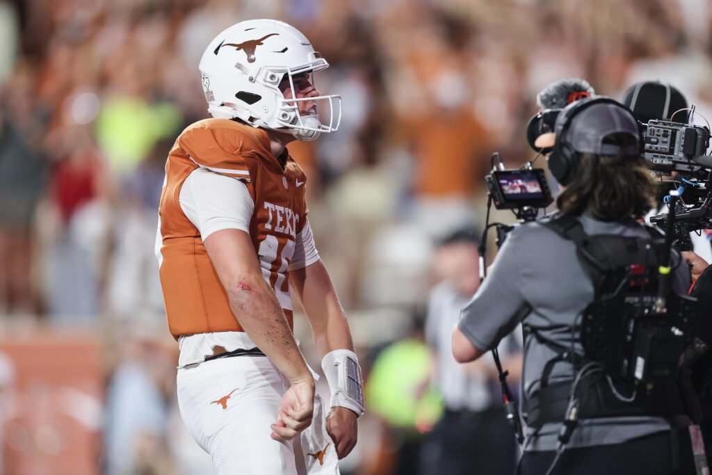 Arch Manning in his Texas uniform reacts beside a television camera after a first-quarter touchdown against Ole Miss.