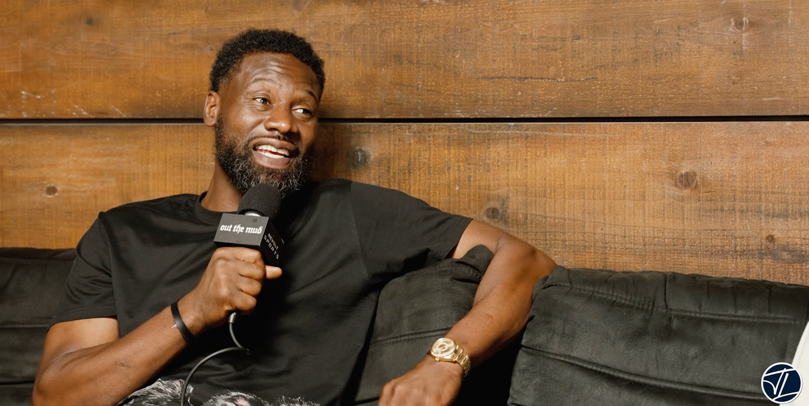 Tony Allen holds an Out The Mud microphone during his conversation with Trevor Ariza.