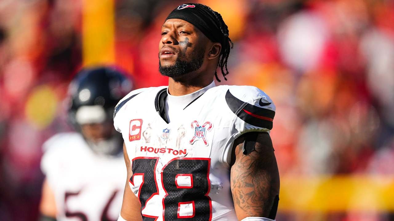 Joe Mixon wearing a white Houston Texans jersey and black headband.