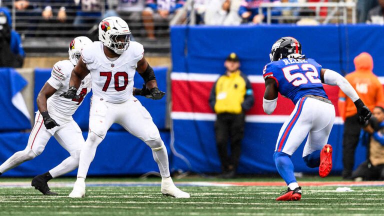 Cardinals tackle Paris Johnson Jr. in a white jersey facing Giants linebacker Arvell Reese.