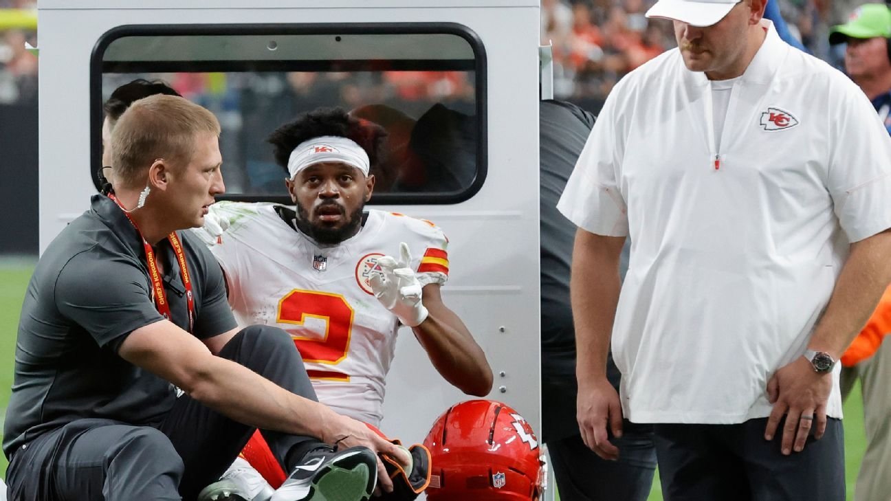 Chiefs receiver Tyquan Thornton seated beside medical staff in a white jersey.