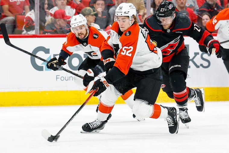 Denver Barkey in an orange Flyers jersey carrying the puck against Carolina.