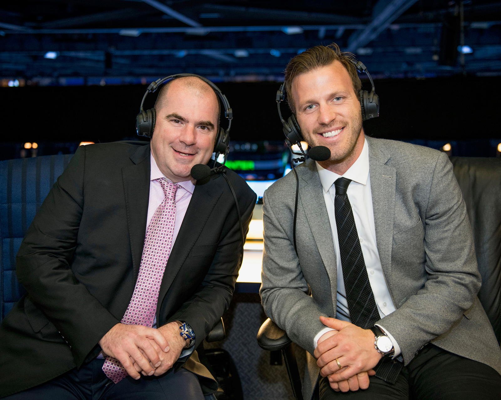 Blues broadcasters Chris Kerber and Joey Vitale wearing headsets in the broadcast booth