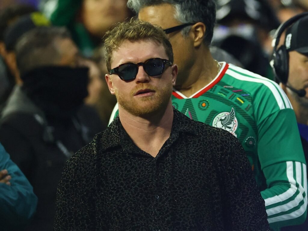 Canelo Alvarez wearing sunglasses among spectators at a football match