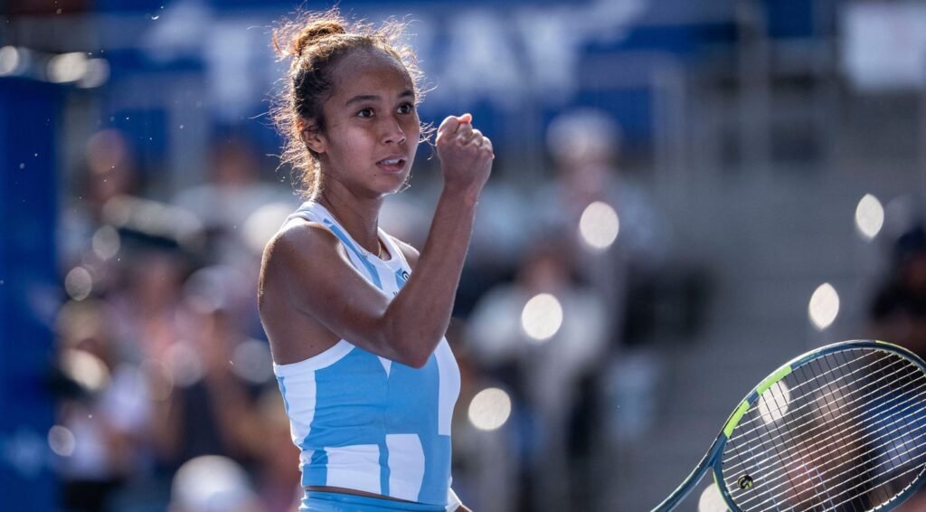 Leylah Fernandez raises her fist with her racket beside her in Tokyo.