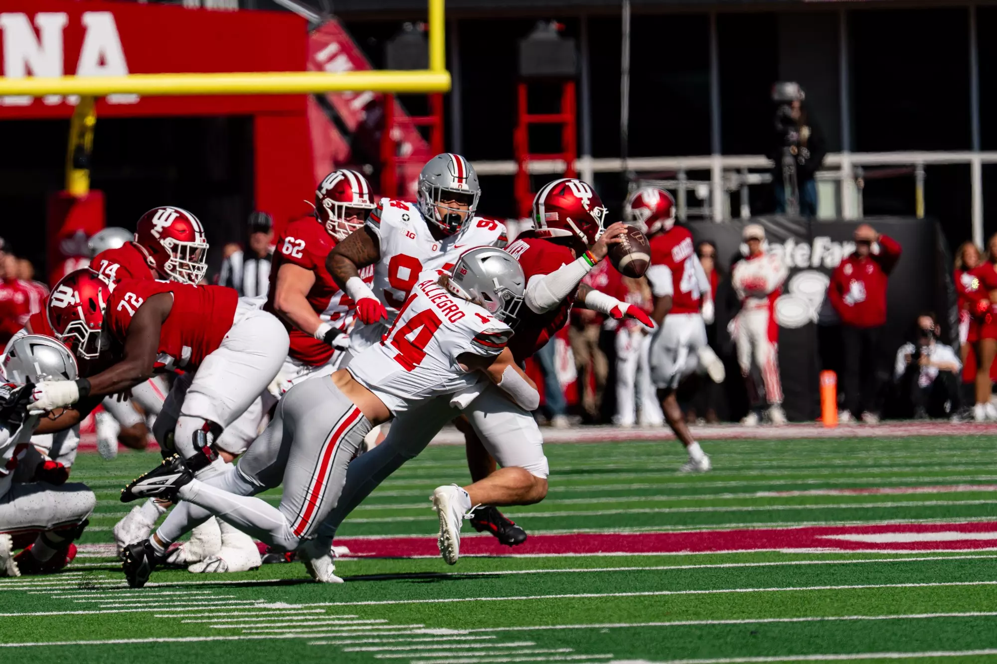 Ohio State defenders tackle an Indiana ball carrier at Memorial Stadium.