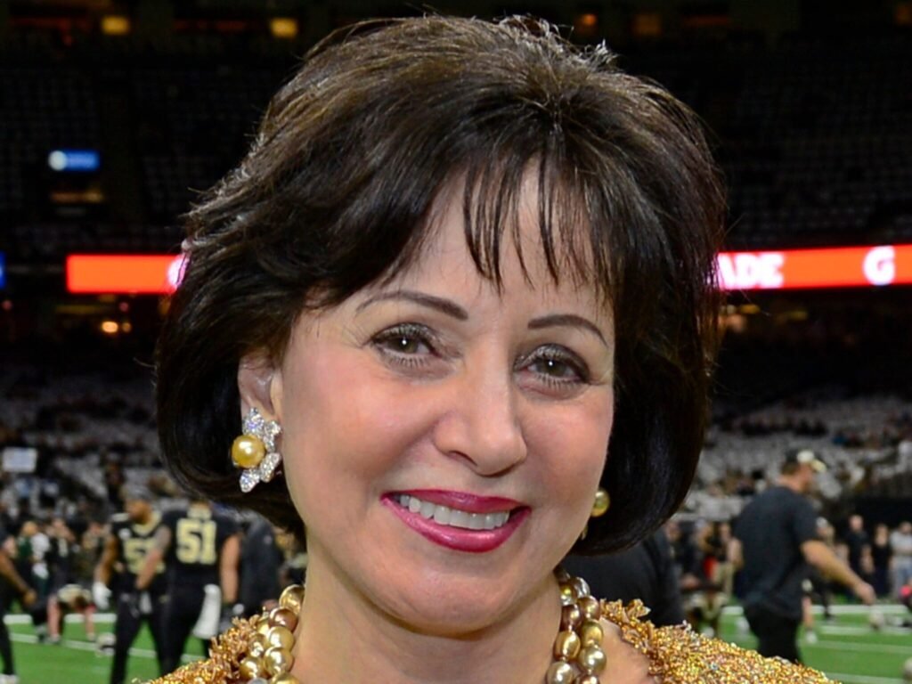 Gayle Benson in a gold jacket at a New Orleans Saints game.