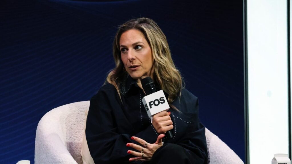 Jessica Berman holds a Front Office Sports microphone while speaking onstage at the Tuned In summit.