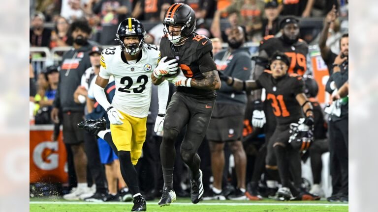 Denzel Boston carries the ball with a Pittsburgh defender alongside him.
