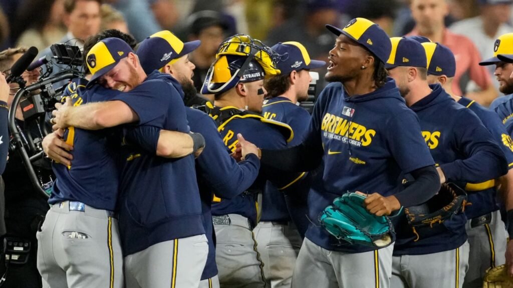 Milwaukee Brewers players embrace on the field after clinching the National League pennant at Dodger Stadium on October 15, 2026.