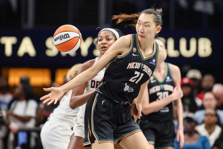 Angel Reese takes the ball from Han Xu during the October 4, 2026 WNBA playoff game at State Farm Arena.