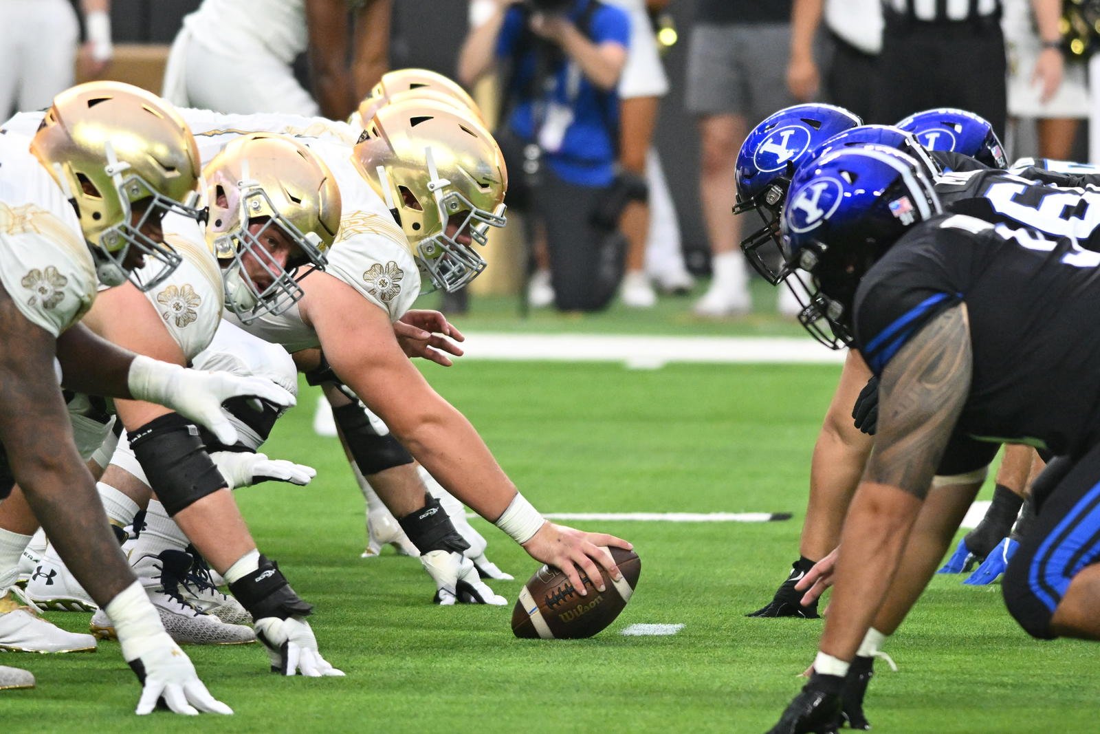 Notre Dame and BYU players facing each other at the line of scrimmage.