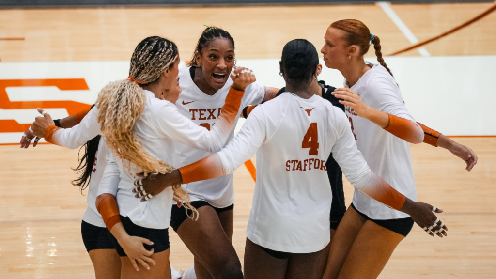 Torrey Stafford, number4, huddles with her Texas volleyball teammates