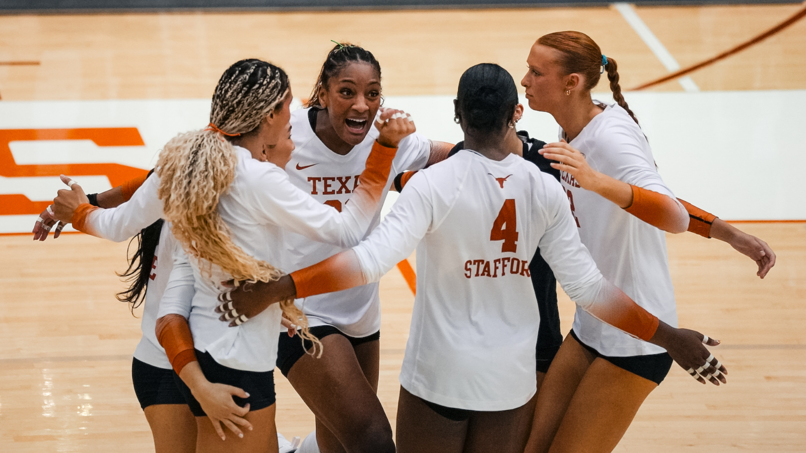 Torrey Stafford, number4, huddles with her Texas volleyball teammates