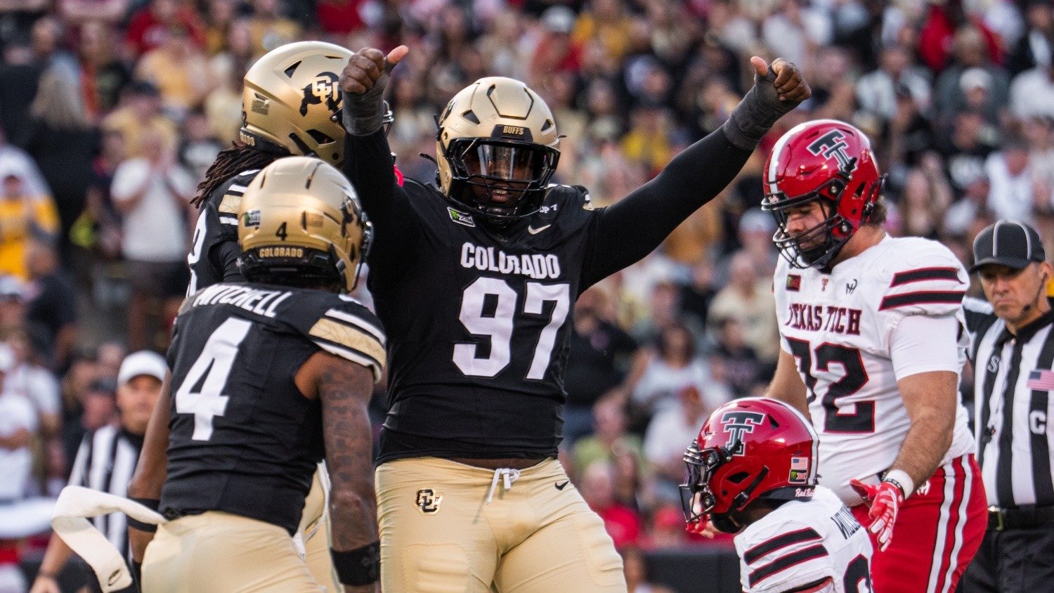 Colorado defensive lineman Santana Hopper raises his arms during a game against Texas Tech.