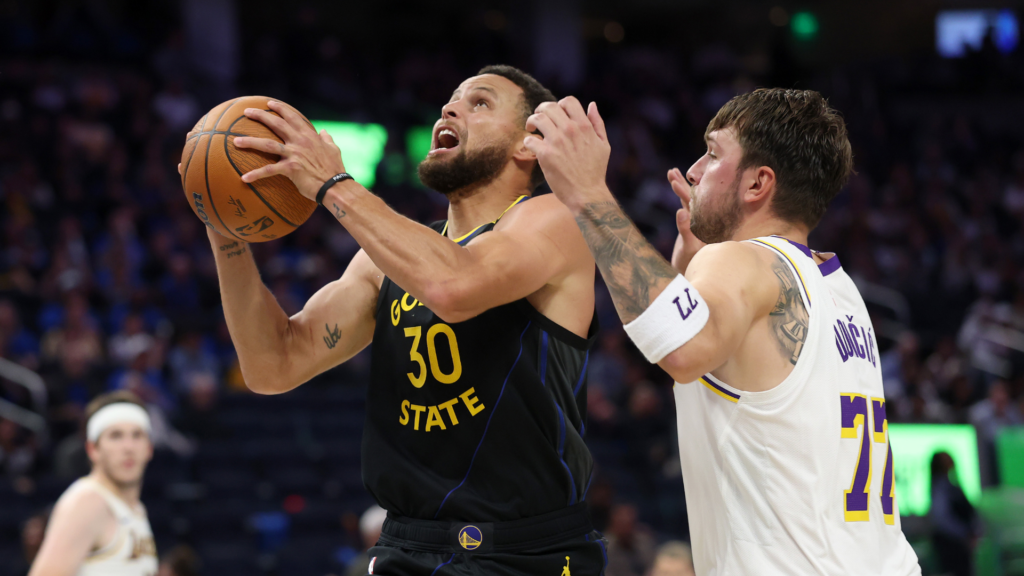 Stephen Curry shoots against Luka Dončić.