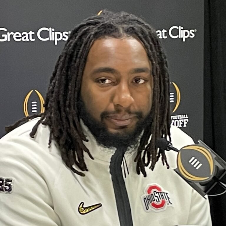 Donovan Jackson speaking at a College Football Playoff media-day table in an Ohio State jacket.