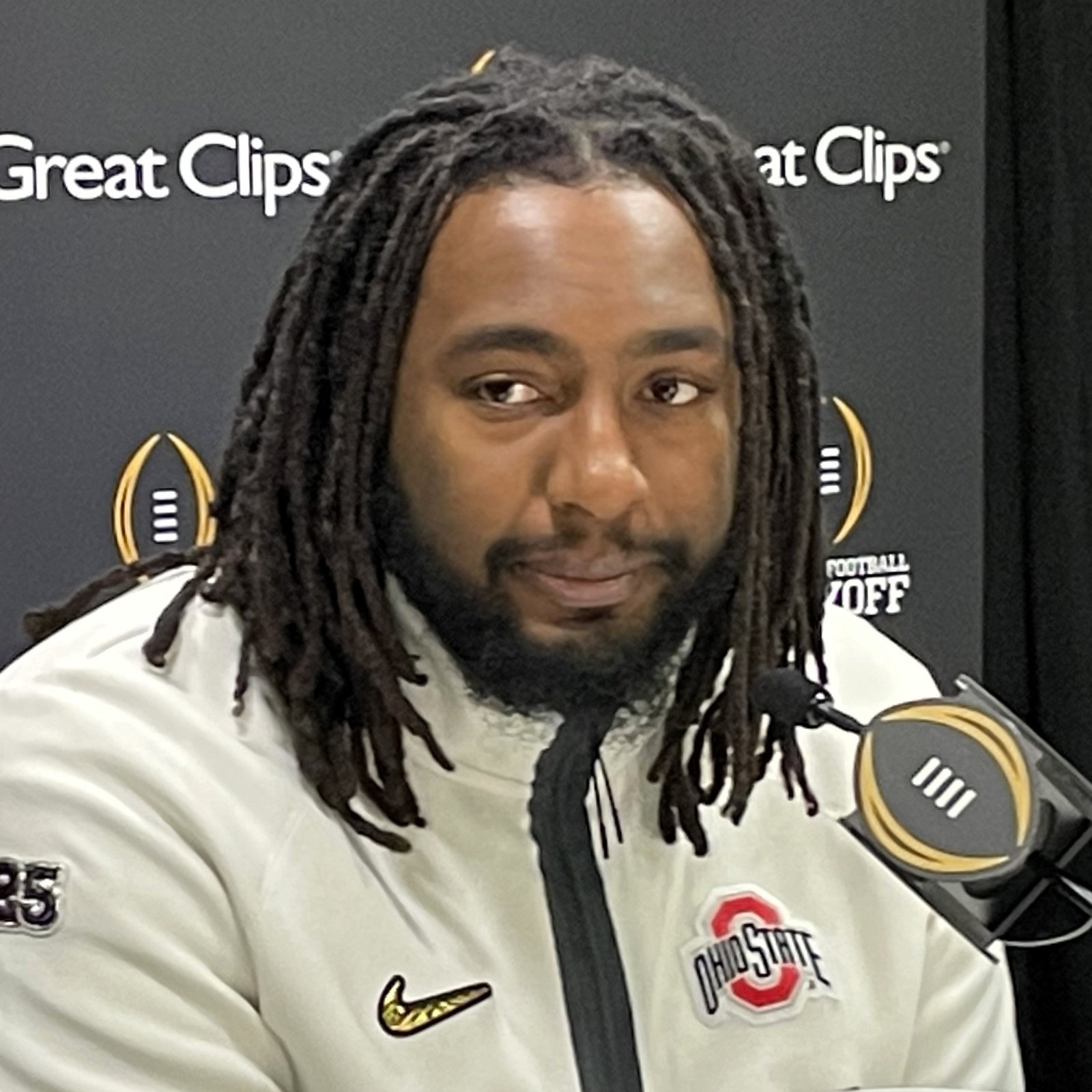 Donovan Jackson speaking at a College Football Playoff media-day table in an Ohio State jacket.